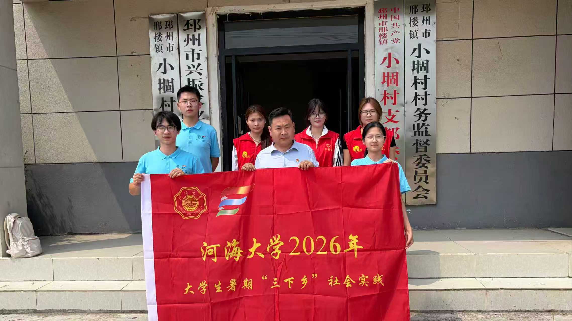 图为实践团与小堌村书记和志愿者的合照