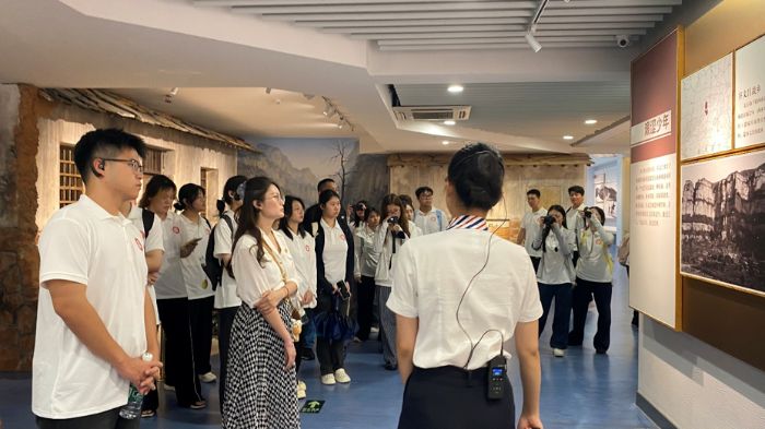 (实践队成员认真倾听解说员讲解谷文昌的英雄事迹)